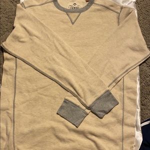 Cream relaxes tommy Bahamas’s shirt